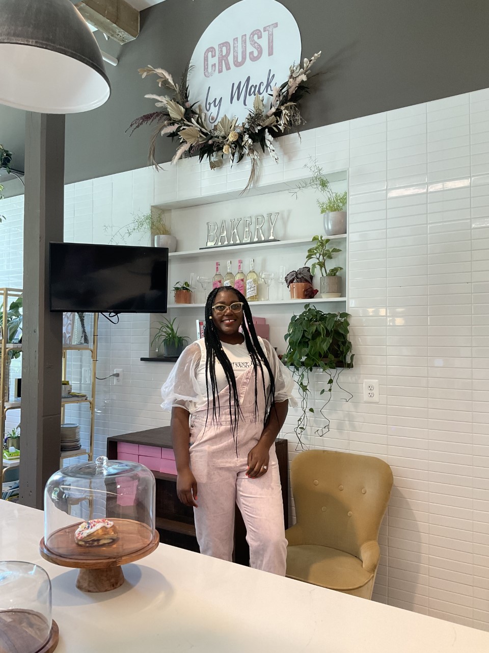 Amanda Mack stands inside her bakery, Crust by Mack