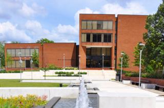 Dark red brick exterior of the Parlett Moore Library on the campus of Coppin State University 