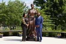 a man and woman pose with statue of Fanny Jackson Coppin